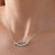 “Elegant Curve Necklace with Cubic Zirconia Detailing”